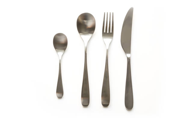istock Set of metal silverware, knife, fork, spoon, tea spoon on white background. Top view. 1161591186