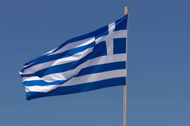 istock Greek flag flying from a pole and clear blue sky 1161592071