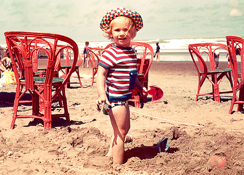 Vintage photo of a cute blonde girl at the beach
