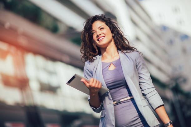istock Young business woman using digital tablet outdoor 1161596402