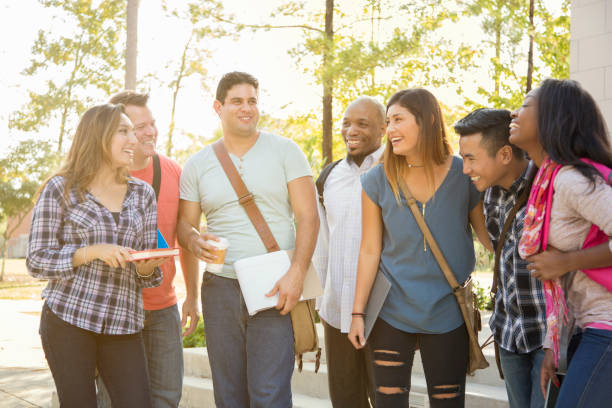 istock College student friends share laughs together on university campus. 1161598317