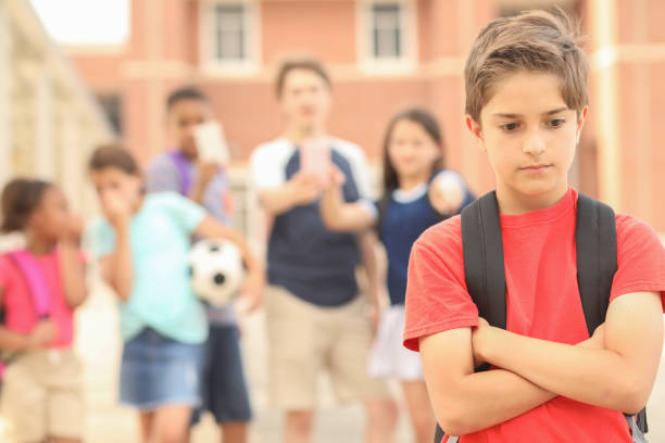 istock Elementary age boy being bullied at school. 1161598453