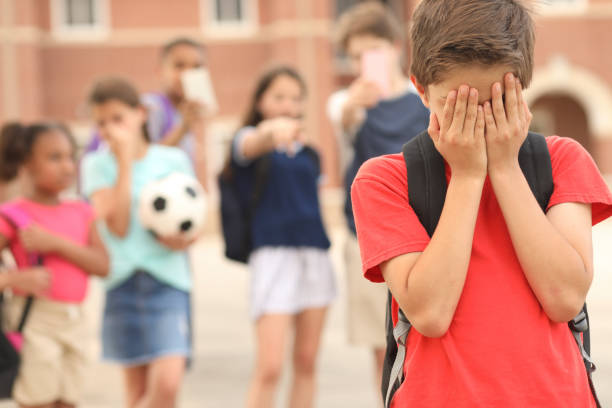 istock Elementary age boy being bullied at school. 1161598456