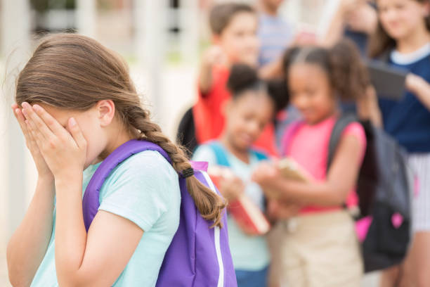 istock Elementary age girl being bullied at school. 1161598476