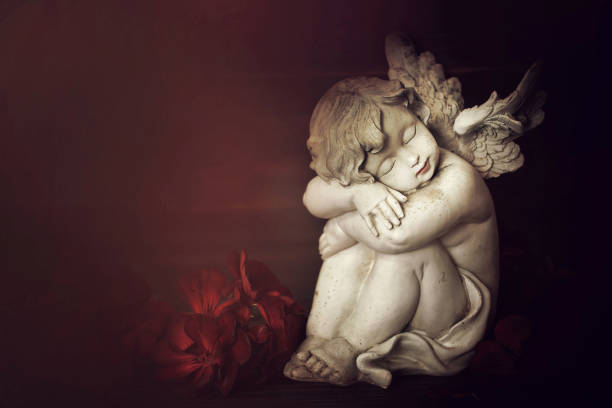 istock Angel and flowers on dark background 1161598939