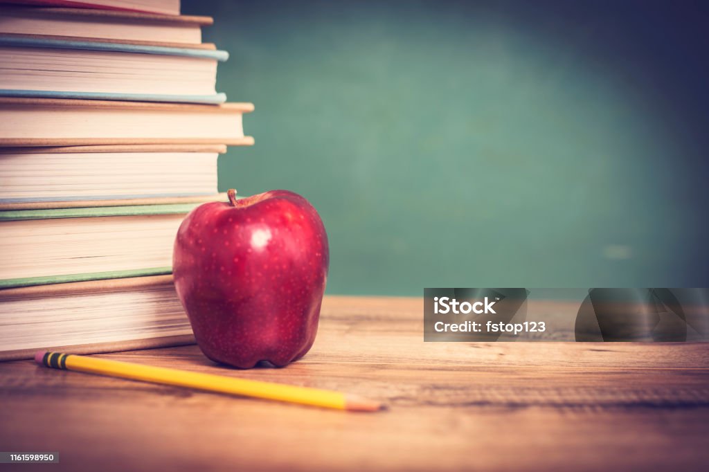 Textbooks Red Apple On Wooden School Desk With Chalkboard Pencils Stock  Photo - Download Image Now - iStock