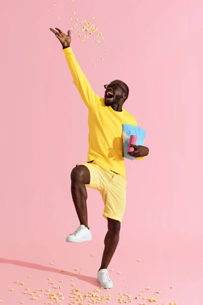 istock Happy man in cinema glasses having fun throwing pop corn in air 1161599213