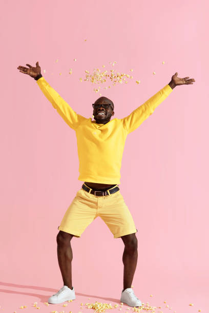 istock Happy man in cinema glasses having fun throwing pop corn in air 1161599785