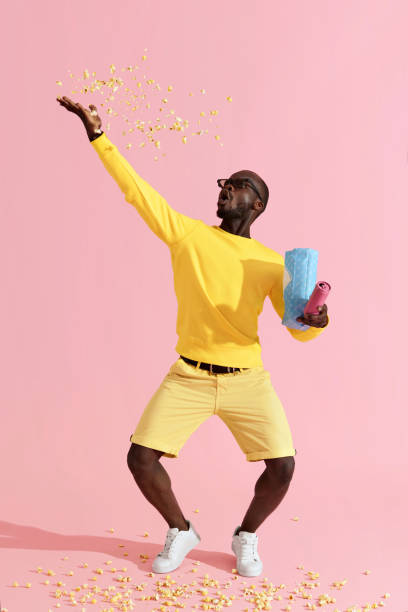 istock Happy man in cinema glasses having fun throwing pop corn in air 1161599830
