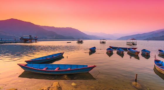 Different color Boats parked in Phewa Lake after sunset. Pokhara nepal.