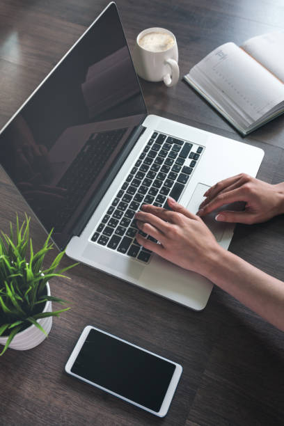 Getting down to work. Woman working on a laptop.