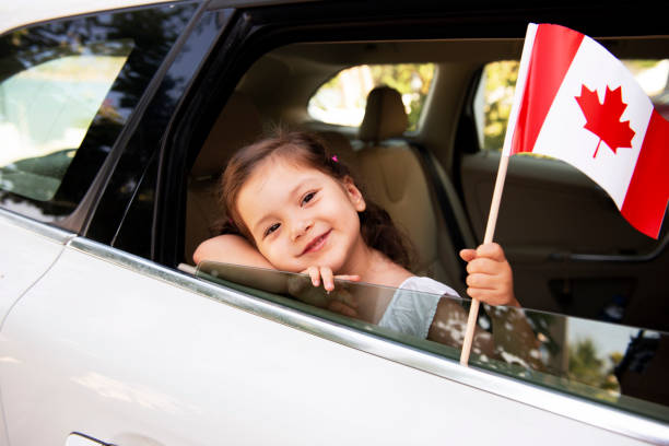 istock Girl Holding Canadian Flag 1161601372