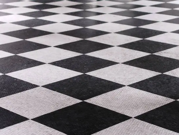 Photo of Black and white checkered marble floor pattern