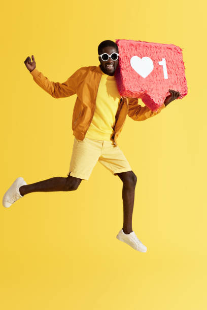 istock Like. Cheerful man jumping with social media like icon 1161606465