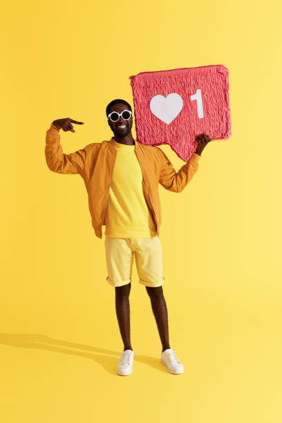 istock Like. Happy man with heart like icon pinata 1161606577