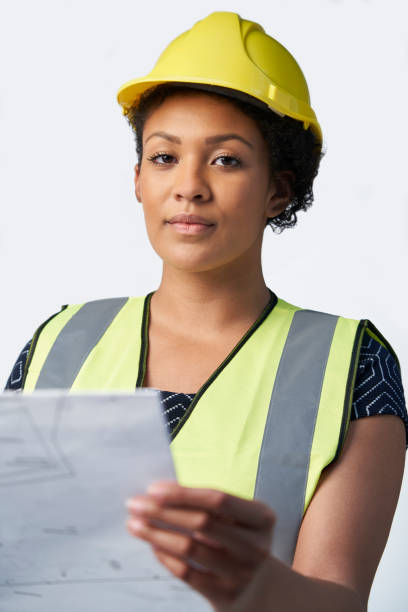 istock Studio Portrait Of Female Architect With Studying Plans Against White Background 1161608201
