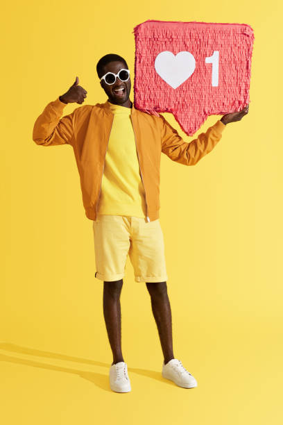 istock Smiling black man with like icon pinata showing thumbs up 1161609421