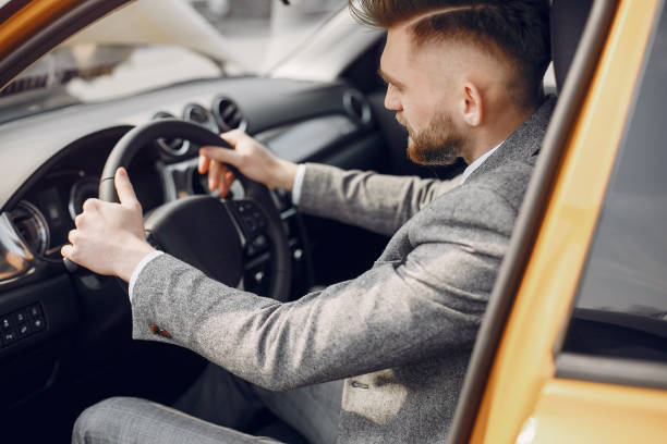 istock Handsome and elegant man in a car salon 1161611095