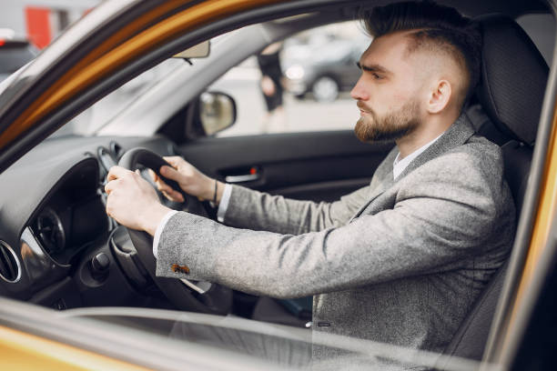 istock Handsome and elegant man in a car salon 1161611149