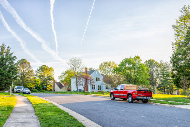 Northern Virginia Fairfax county residential neighborhood in spring with houses Herndon, USA - April 23, 2019: Northern Virginia Fairfax county residential neighborhood in spring with houses and road cars parked by lawn and sidewalk herndon virginia stock pictures, royalty-free photos & images