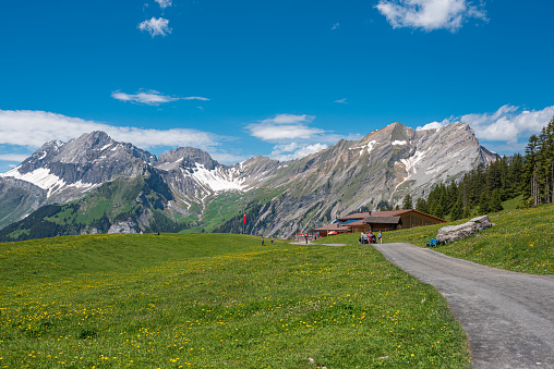 Kandersteg, Switzerland - June 19, 2019: Landscape panorama at the Oeschinen mountain station with the mountains Large Lohner, Small Lohner and the Bonderspitz in Kandersteg in the Bernese Oberland of Switzerland