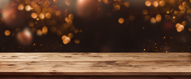 Abstract bokeh background with old rustic wooden table for a christmas dekoration
