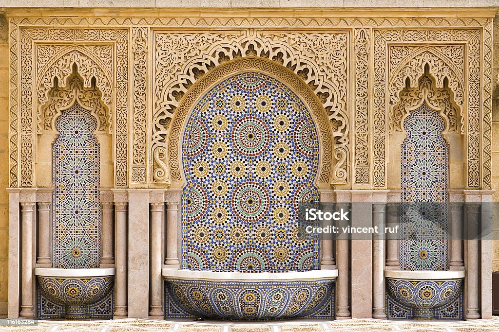 Moroccan tiled fountain Typical moroccan tiled fountain in the city of Rabat, near the Hassan Tower and Mohamed V Mausoleum. The Mausoleum is a true master-work of Moroccan art. The best craftsmen of morocco took part in the work. Morocco Stock Photo