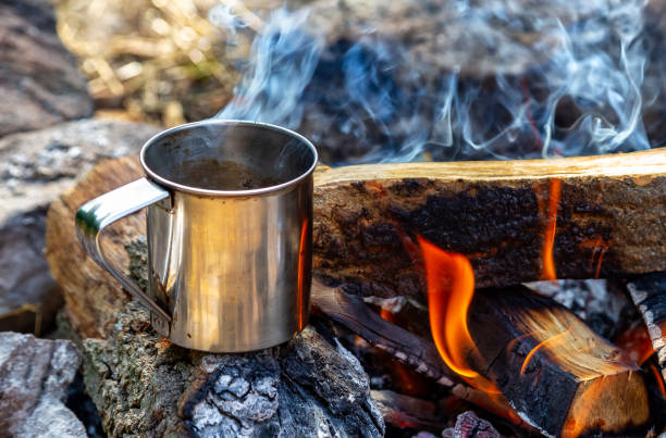 istock steel cup on an open fire in nature. Cooking on fire. Camping in summer. 1161634183