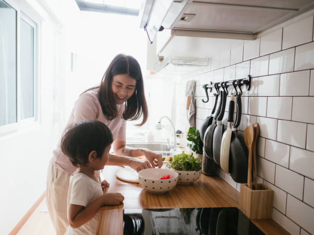 istock Mother and daughter cooking together. 1161638002