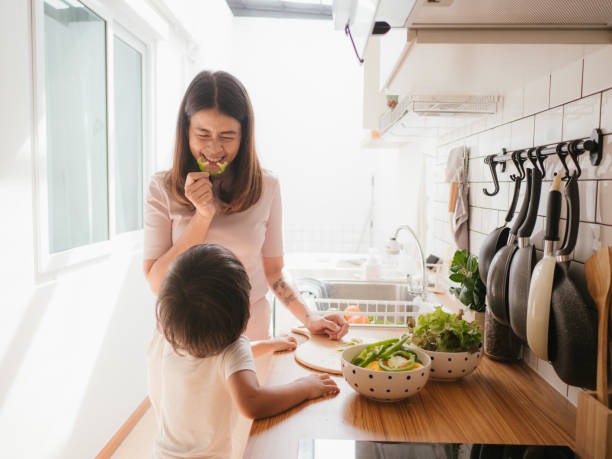 istock Mother and daughter cooking together. 1161638117