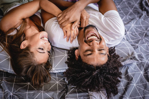 istock Young Couple Lying Bed in bedroom and smiling 1161638240
