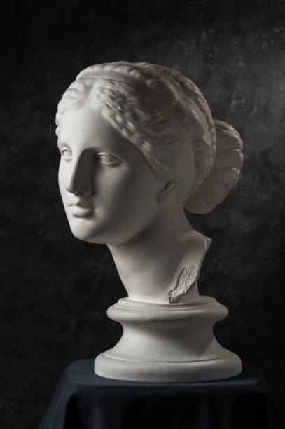 istock Gypsum copy of ancient statue Venus head on a dark textured background. Plaster sculpture woman face. 1161638245
