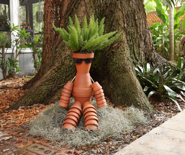 Pot man sitting under a large oak tree