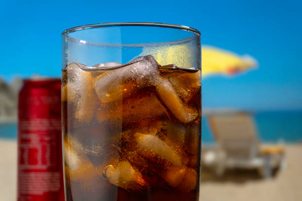 Iced cola on the beach on a sunny day
