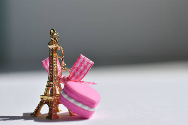 istock Souvenir golden eiffel tower with a purple heart on a white background 1161641386