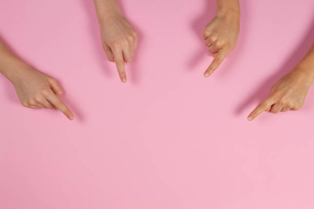 istock Many kids hands pointing to something on pink background 1161643802