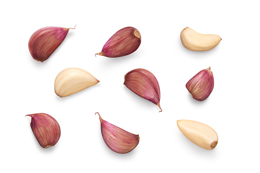 A collection of garlic cloves isolated on a white background.