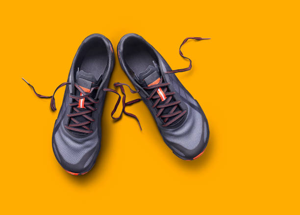 istock Top view of gray and orange trainers 1161646521