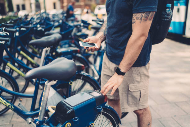 turista en cracovia alquiler de bicicletas a través de la aplicación móvil - bikeshare fotografías e imágenes de stock