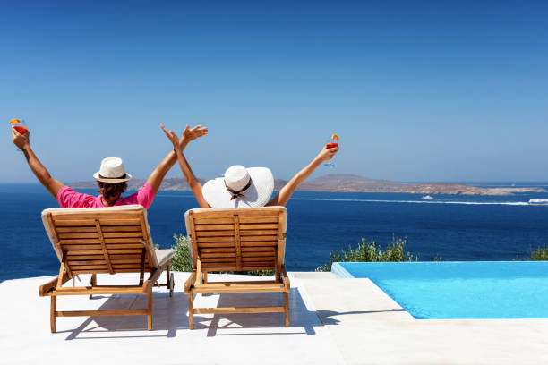 istock Couple enjoys their luxury vacation by the pool 1161649293