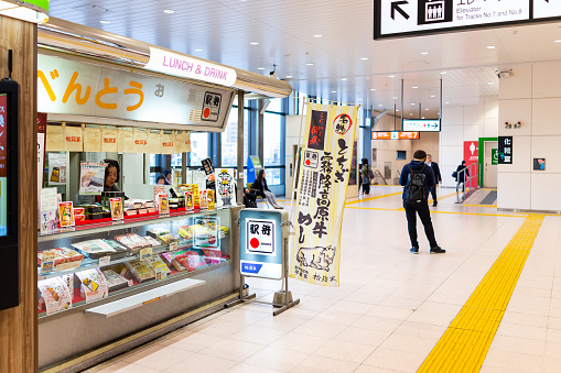 Utsunomiya, Japan - April 4, 2019: Retail food store shop selling ekiben bento boxes in JR train rail station with people walking inside