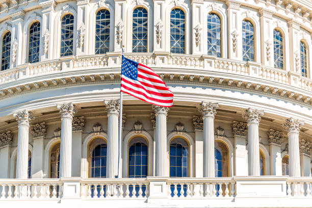 US Congress dome with American flag waving in Washington DC on capitol hill national mall closeup US Congress dome with American flag waving in Washington DC on capitol hill national mall closeup metamorphic rock stock pictures, royalty-free photos & images