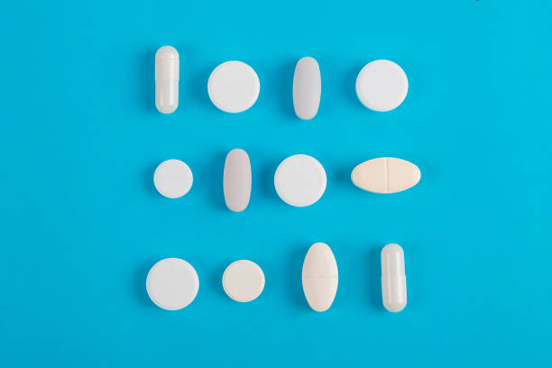 istock Assorted pharmaceutical medicine pills, tablets and capsules over blue background 1161653223
