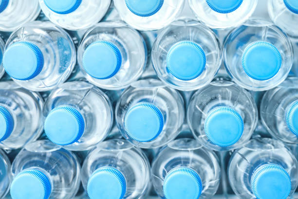 istock Rows of many transparent plastic bottles with drinking water supply in white refrigerator. Mineral water stack storage in fridge to drink on hot summer day. Healthcare and dehydration prevention 1161655618