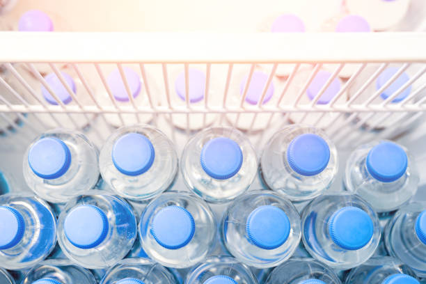 istock Rows of many transparent plastic bottles with drinking water supply in white refrigerator. Mineral water stack storage in fridge to drink on hot summer day. Healthcare and dehydration prevention 1161655622