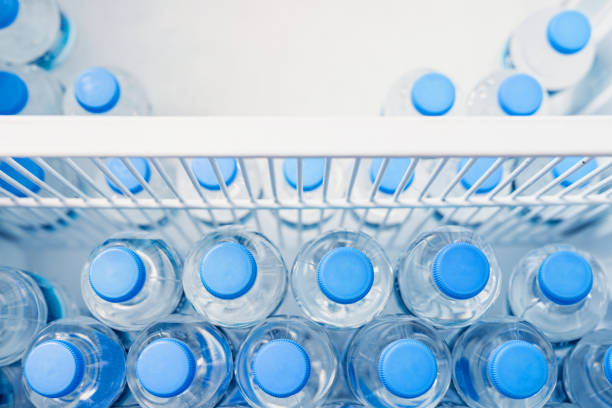 istock Rows of many transparent plastic bottles with drinking water supply in white refrigerator. Mineral water stack storage in fridge to drink on hot summer day. Healthcare and dehydration prevention 1161655623