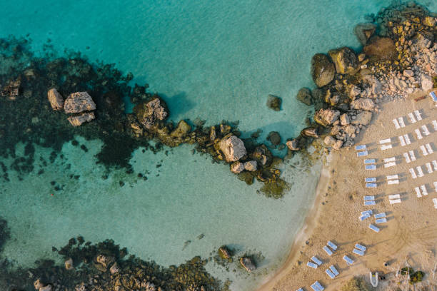 Scenic aerial view of beach with blue umbrellas on Cyprus Scenic aerial view of crowded beach with blue umbrellas on Cyprus nicosia cyprus stock pictures, royalty-free photos & images