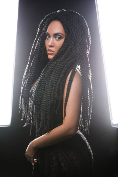 istock stylish model looking into the camera. black long hair. dreadlocks 1161657321