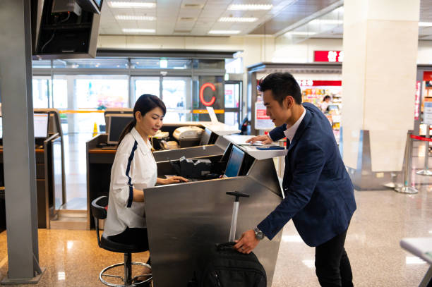 istock Businessman with luggage at check-in counter 1161658210