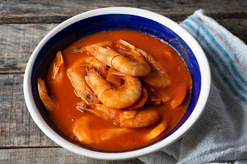 Traditional mexican shrimp soup on wooden background